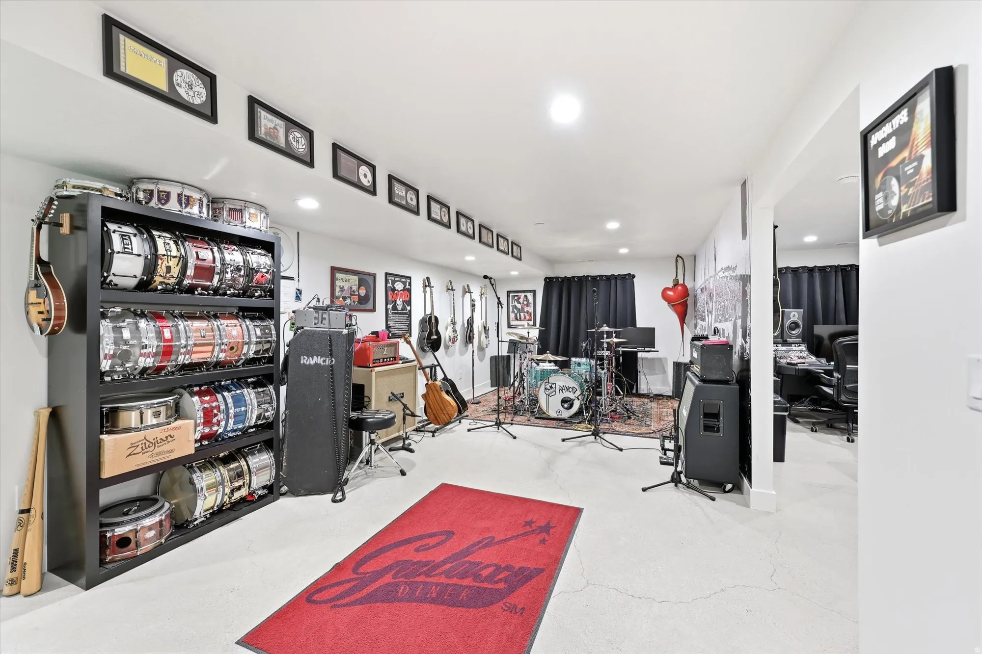 Dedicated creative space featuring recessed lighting, durable concrete flooring, and an archway leading to an additional room