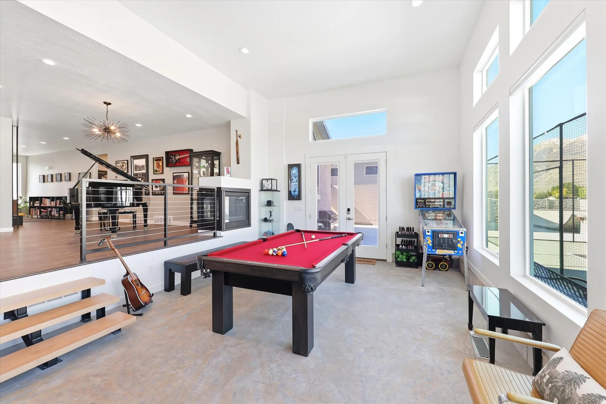 Recreation space featuring a pool table, high ceilings, large windows, French doors, and a built-in fireplace with display shelving