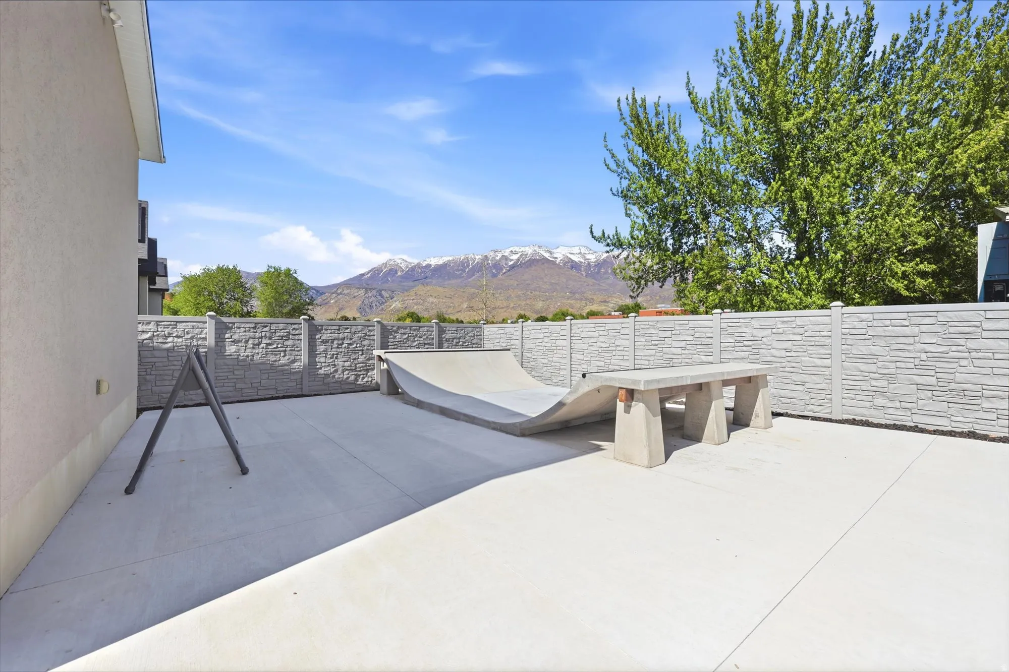 Expansive concrete patio with a concrete barrier fence