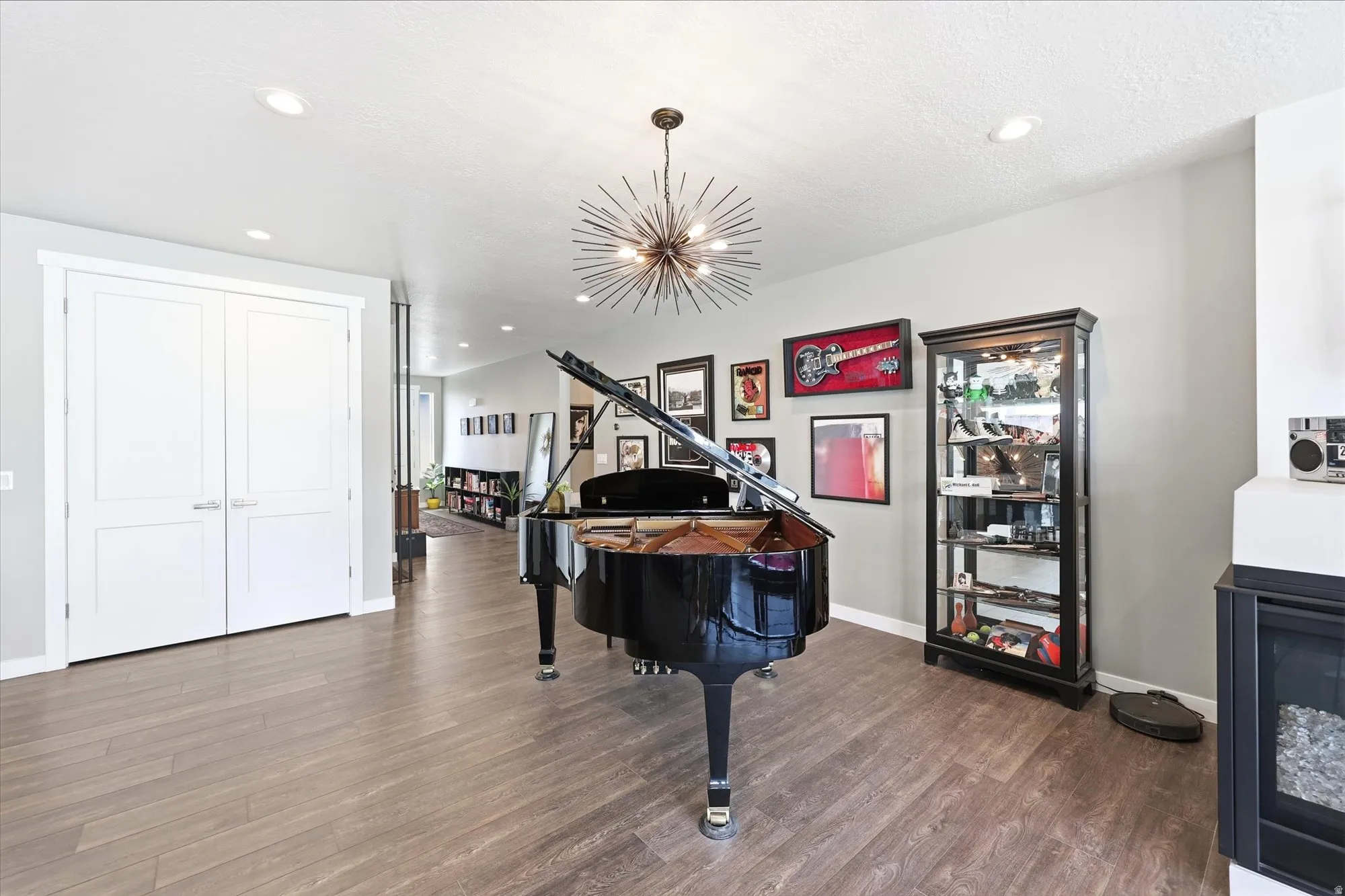 Spacious interior featuring wood-finish flooring, recessed lighting, and a contemporary chandelier