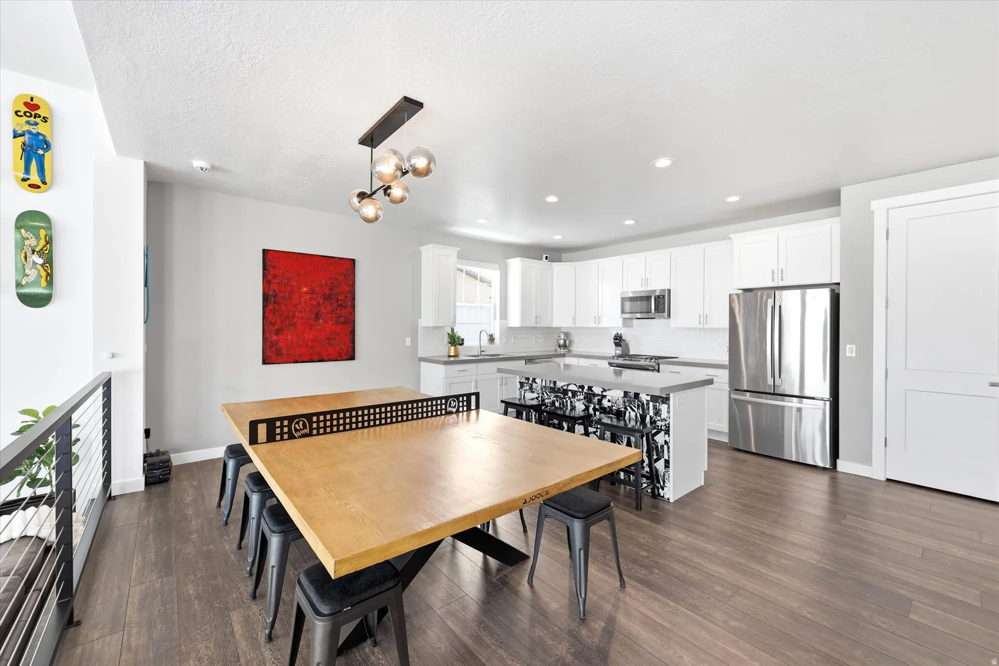 Open-concept kitchen and dining area featuring wood-finish flooring