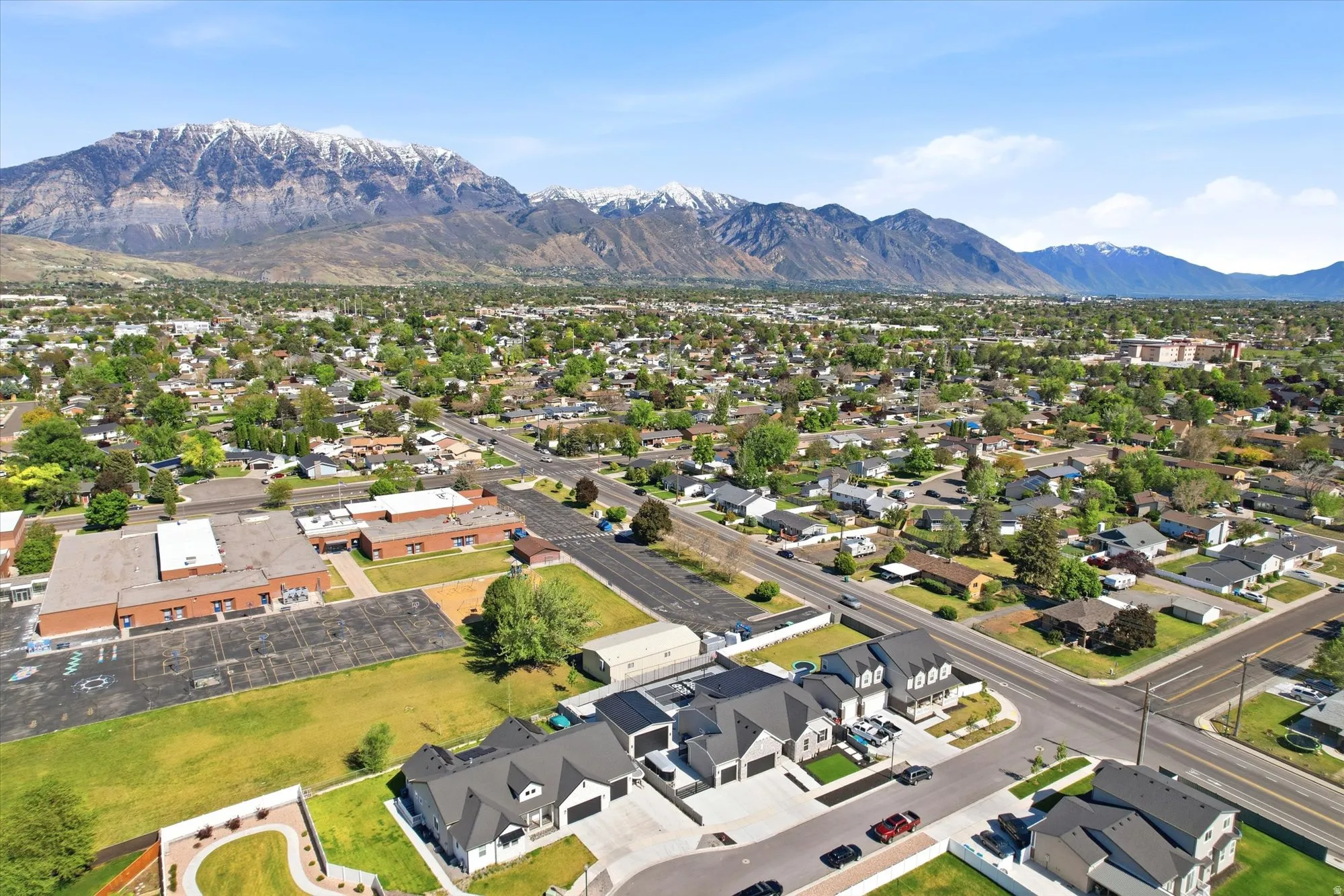 Expansive residential area featuring a distinct mountain backdrop with snow-capped peaks