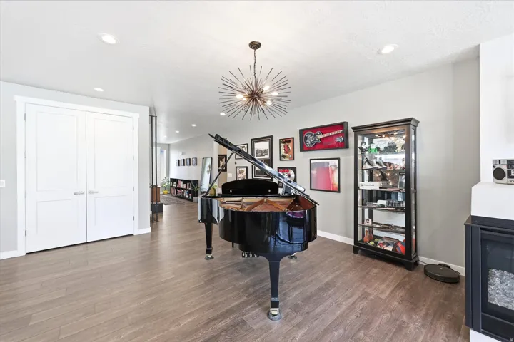 Spacious interior featuring wood-finish flooring, recessed lighting, and a contemporary chandelier