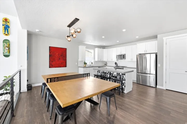 Open-concept kitchen and dining area featuring wood-finish flooring