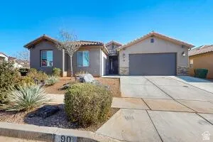Stucco exterior residence with a concrete tile roof and a two-car garage