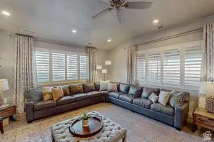Spacious living area featuring ample natural light from multiple windows