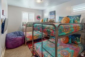 Room featuring light-colored walls, recessed lighting, and dual windows with white louvered shutters