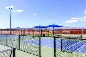 Tennis court with a durable hard surface, complete with court lines and a net