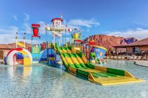 Resort-style water park featuring multiple water slides, interactive play structures, and a spacious pool area