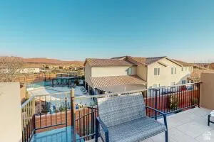 Rooftop patio featuring iron railings and a sweeping desert landscape