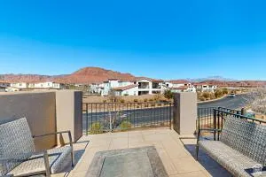 Outdoor balcony with a tiled surface and black metal railing, featuring a built-in fire pit
