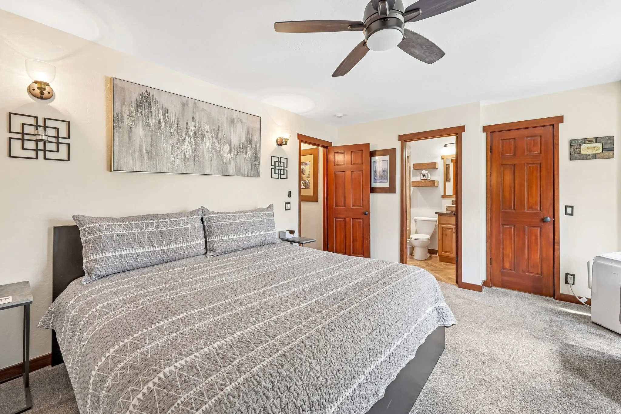 Carpeted bedroom featuring a ceiling fan, recessed lighting, and rich wood-finish doors and trim