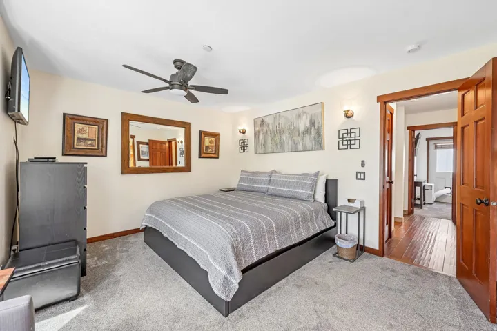 Plush carpeting enhances this room featuring a ceiling fan, recessed lighting, and wall sconces