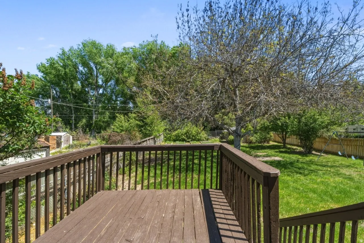 Step out from the kitchen onto the back deck and take in a generous yard full of mature trees and green space. A great spot for morning coffee or an evening unwind, with plenty of room to spread out below.