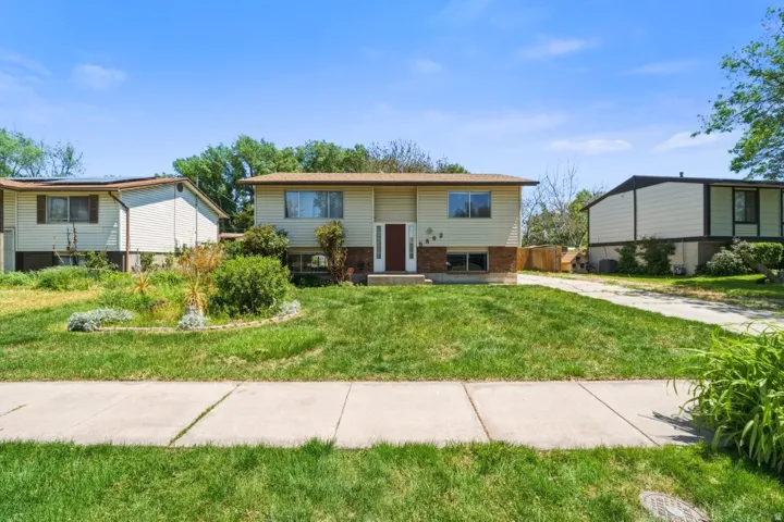 Classic split-entry home in Roy with great curb appeal and a spacious, lush front lawn. Mature trees, established landscaping, and a wide concrete driveway welcome you home. Solid brick and siding exterior with plenty of room to make it your own.