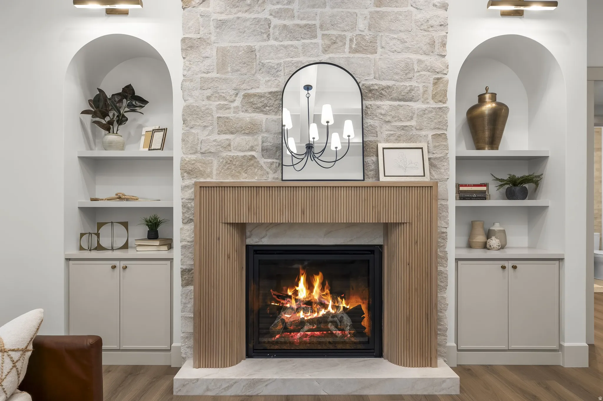 Stone-clad fireplace with a wood-finish mantel and hearth
