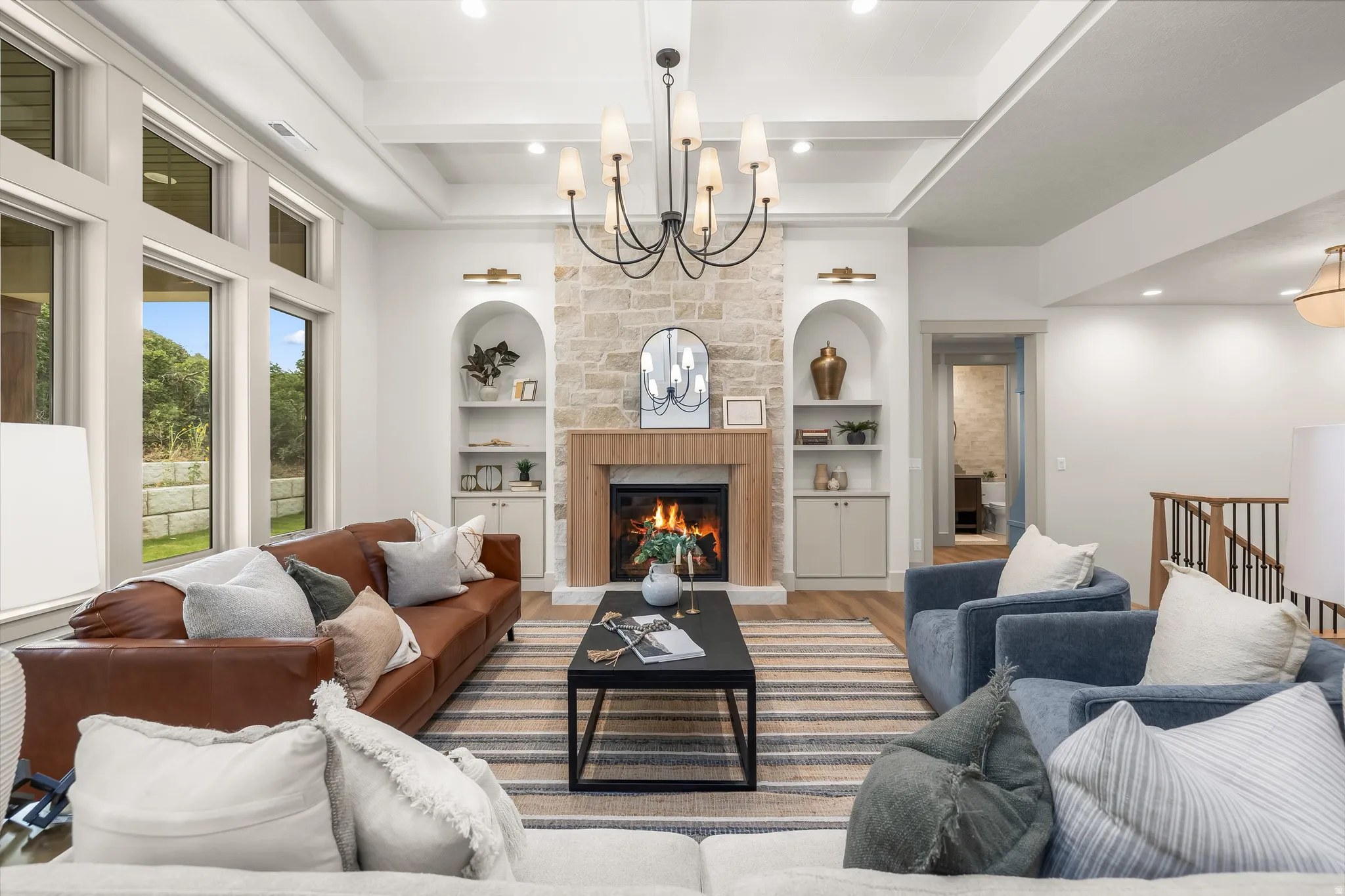 Stone-clad fireplace with wood-finish mantel and built-in arched shelving