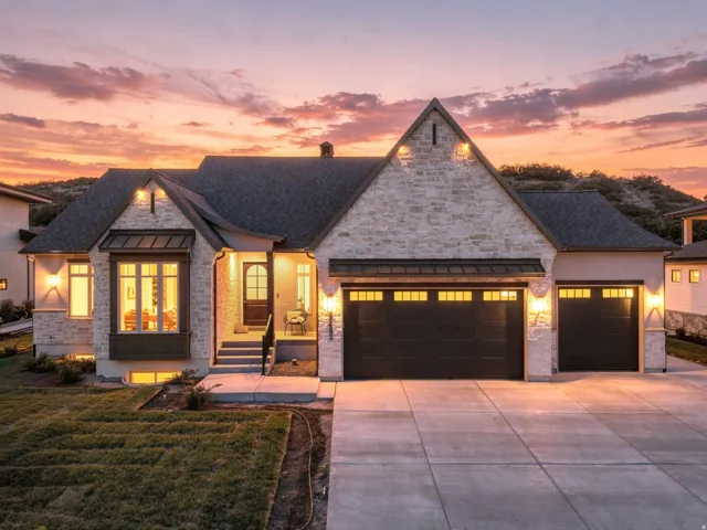 Stone veneer exterior with dark shingle roofing