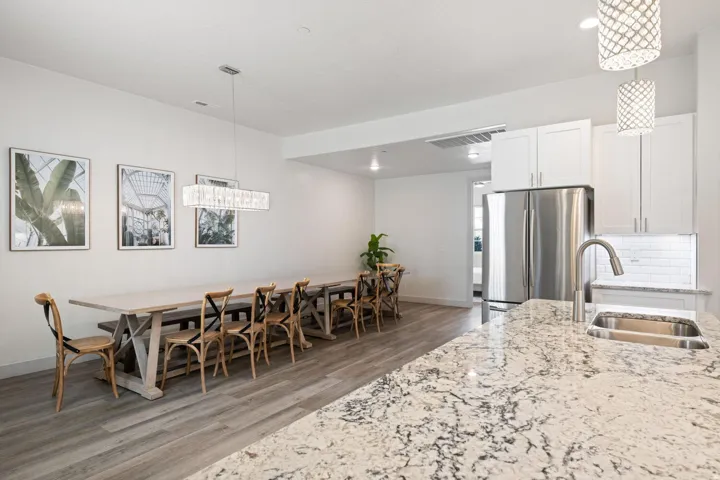 Contemporary kitchen island with a stone countertop and undermount stainless steel sink