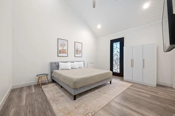 Vaulted ceiling with wood-plank finish and recessed lighting