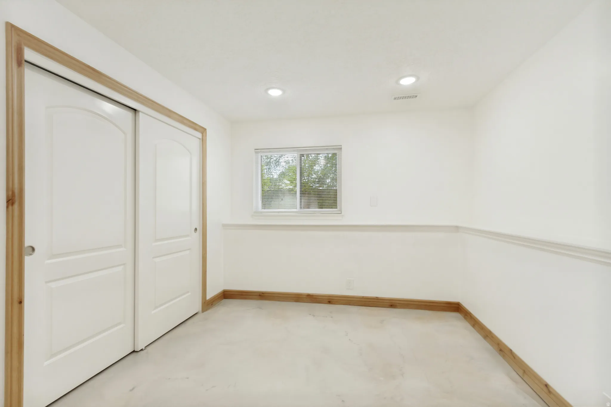 White walls with chair rail molding and wood-finish baseboards