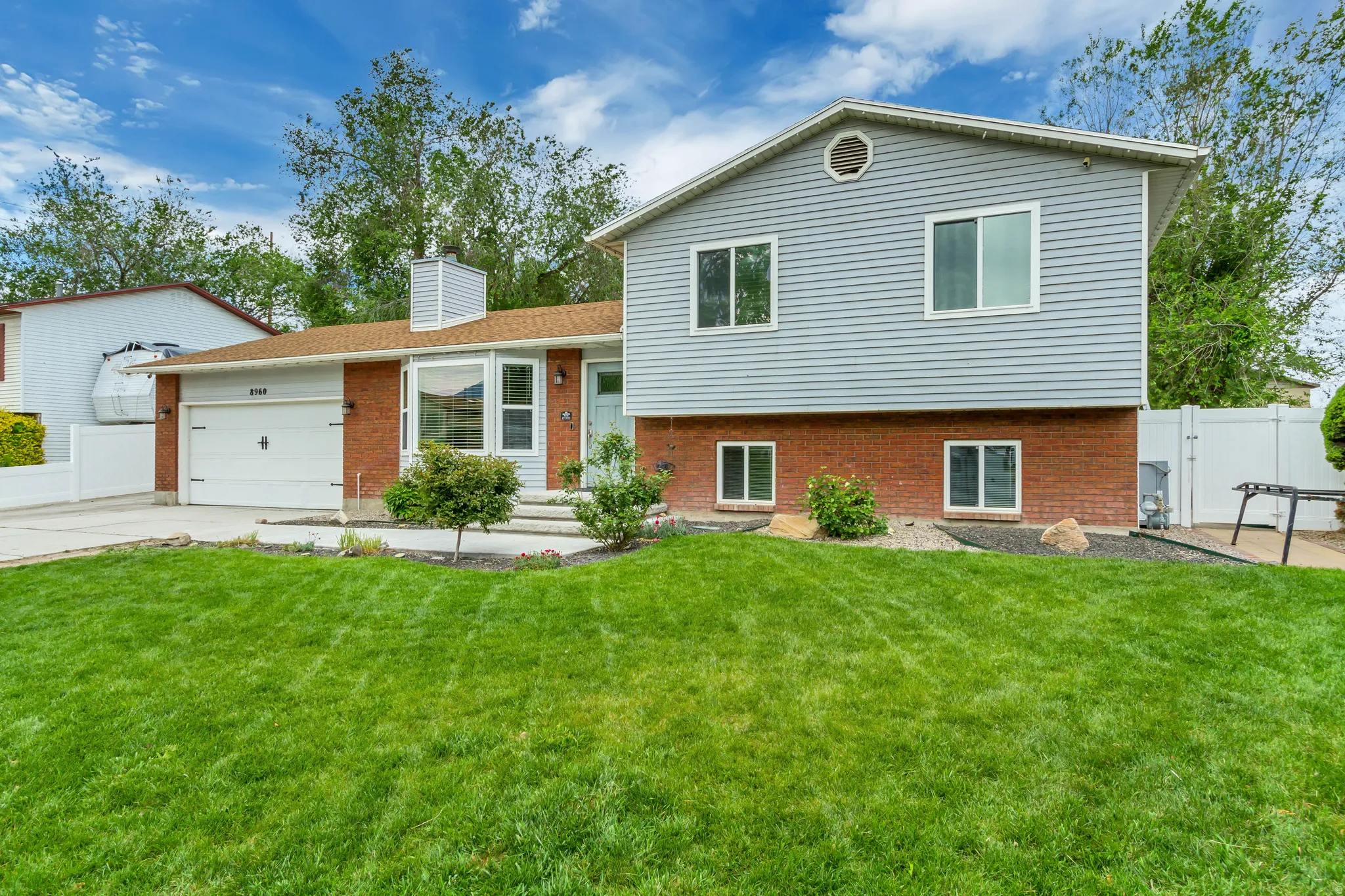 Split-level residence featuring a brick and siding exterior