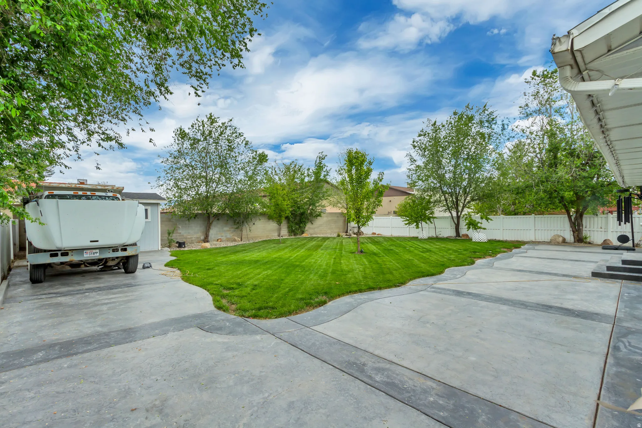Expansive concrete patio with contrasting darker concrete accents and steps