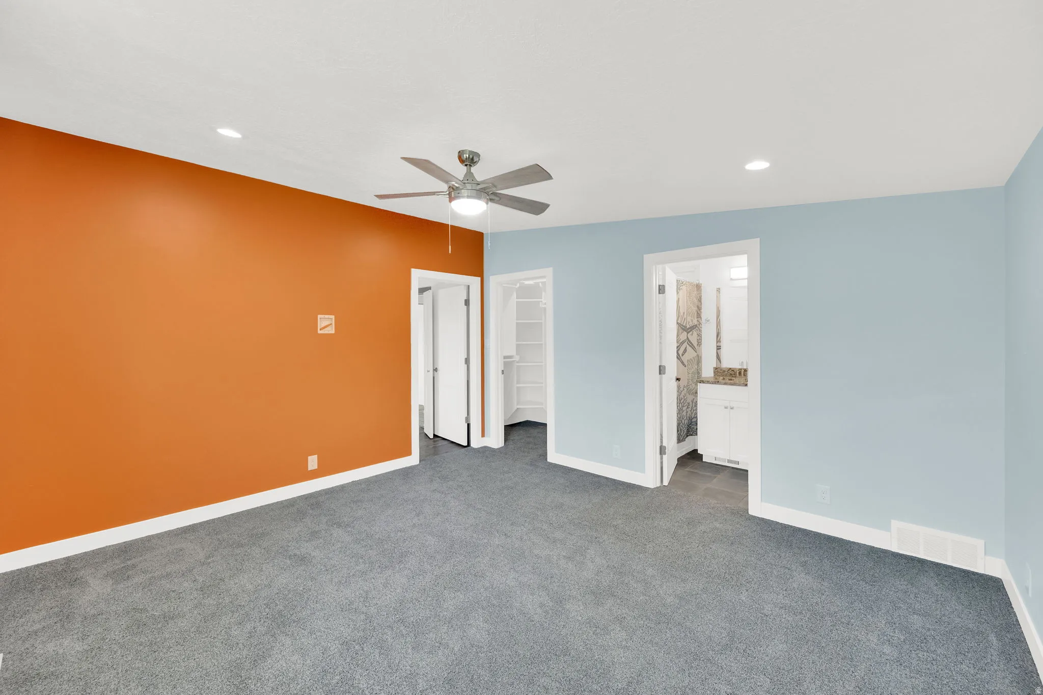 Spacious room featuring carpeting, recessed lighting, and a ceiling fan