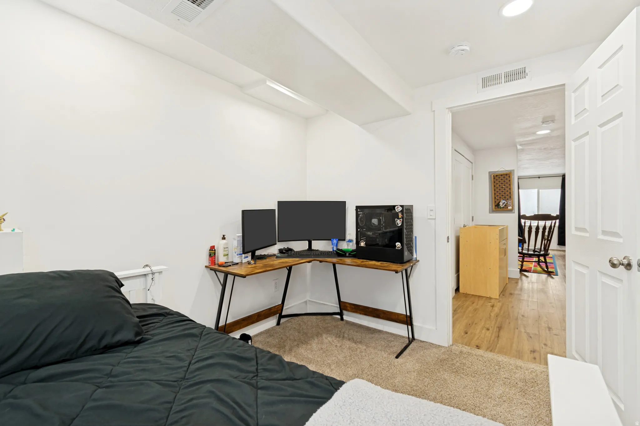 Bright room featuring white walls and a carpeted floor