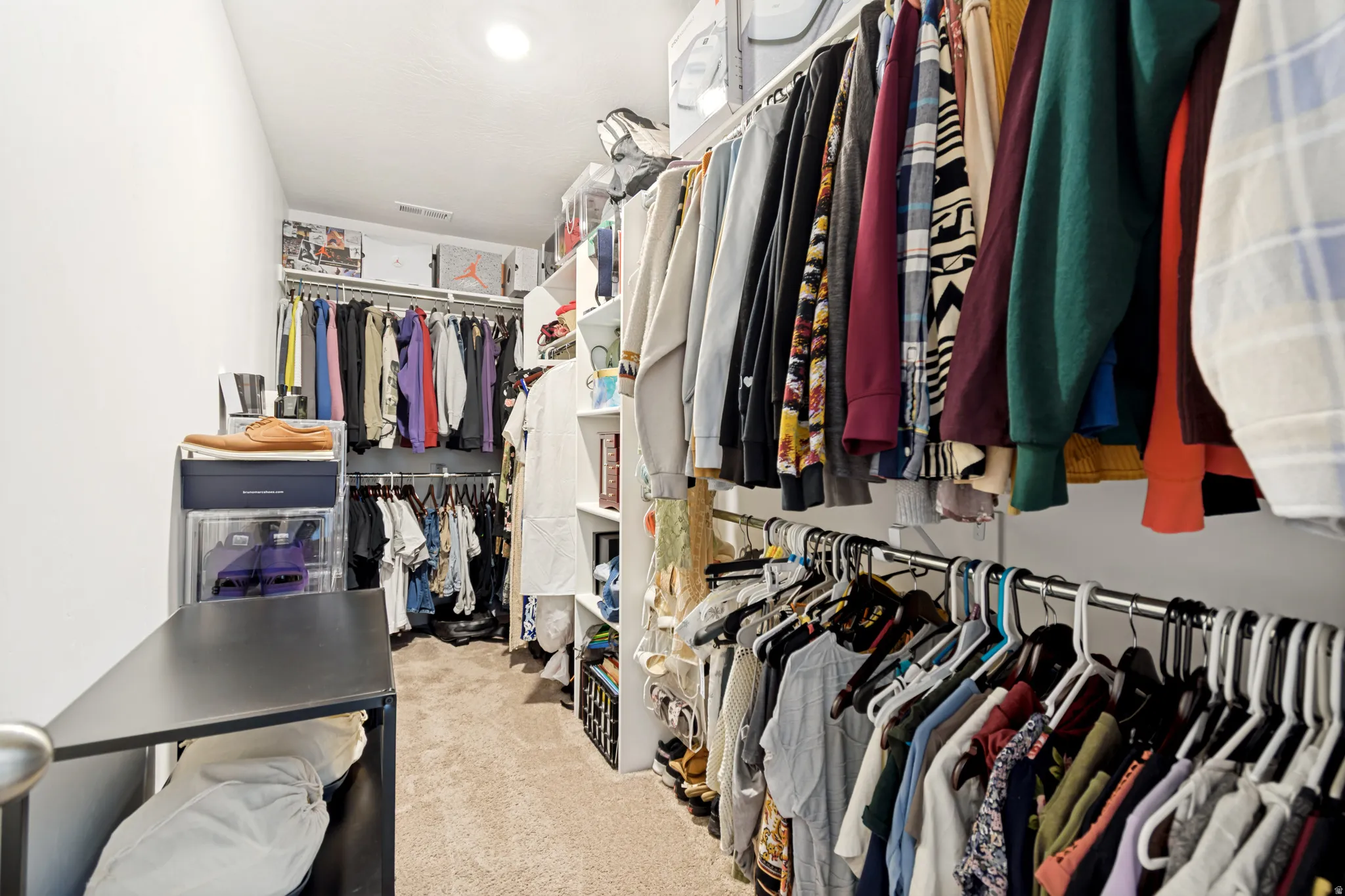 Expansive closet featuring carpeted flooring and recessed lighting