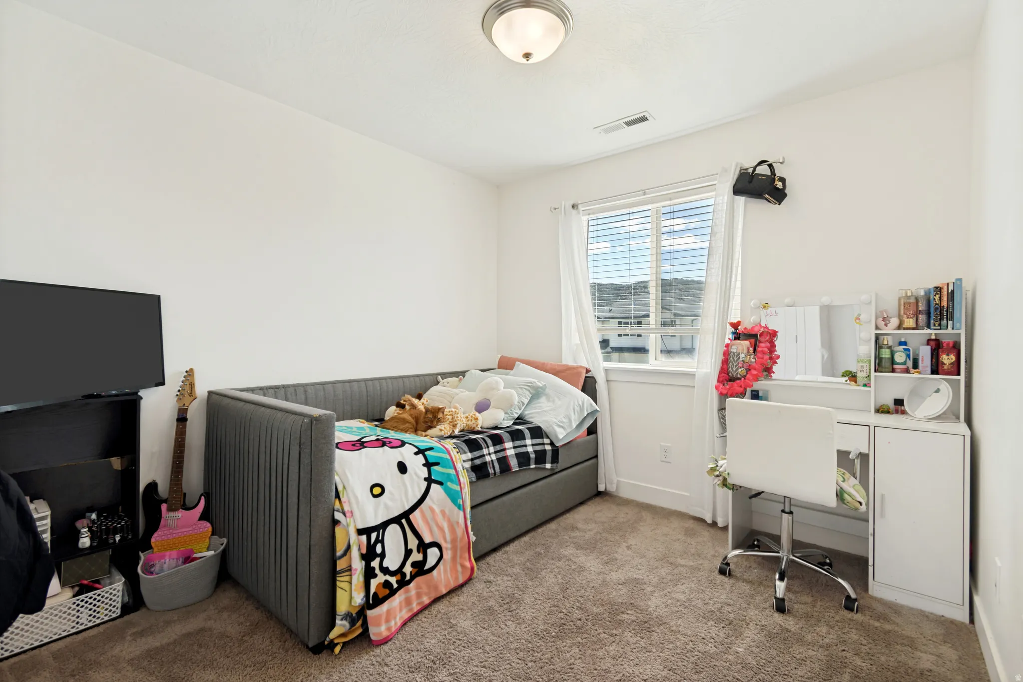 Carpeted room featuring a double-pane window, white trim, and a flush mount ceiling light