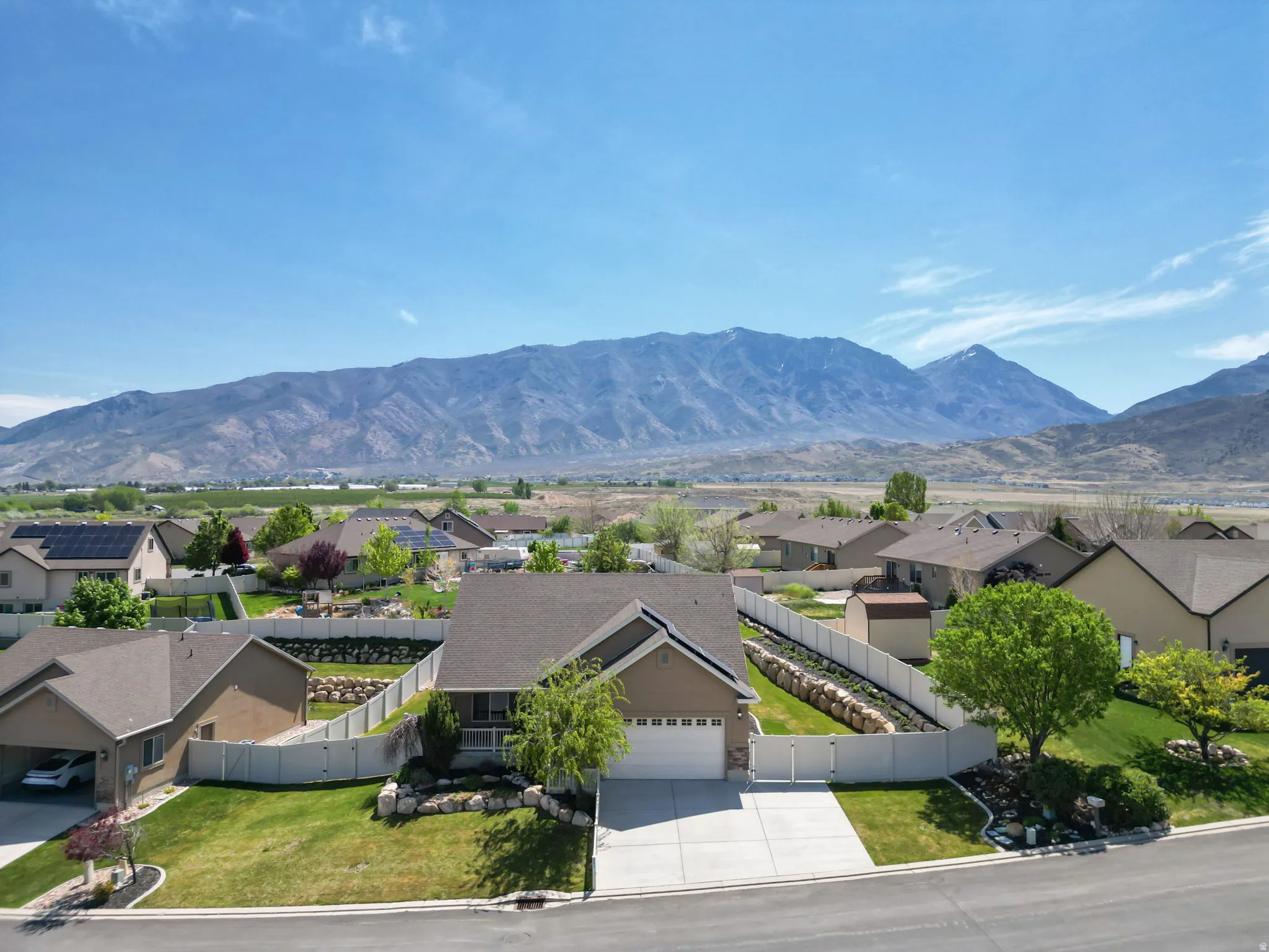 Single-story residence featuring a two-car garage, concrete driveway, and front lawn