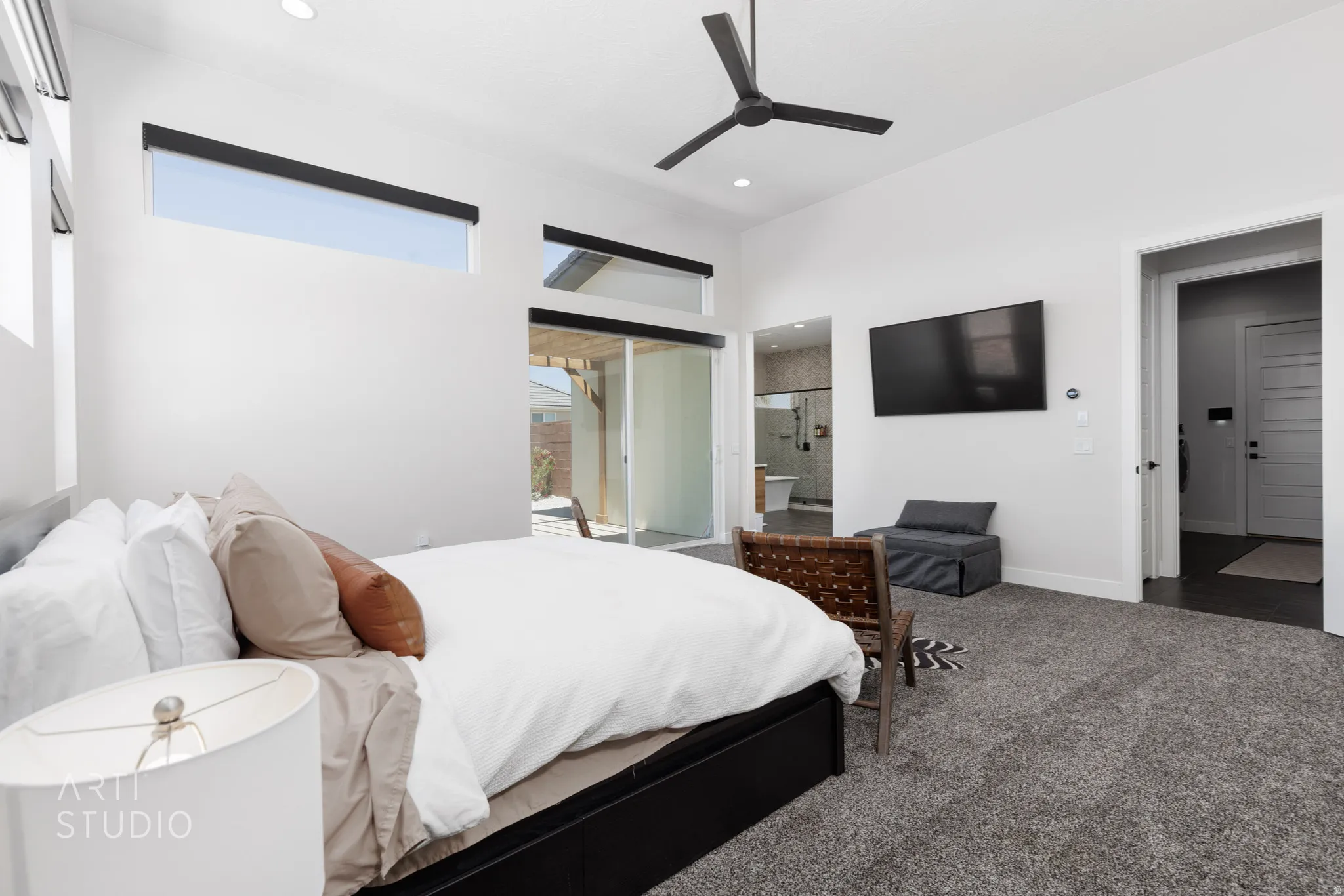 Vaulted ceilings with recessed lighting, high windows, and a ceiling fan