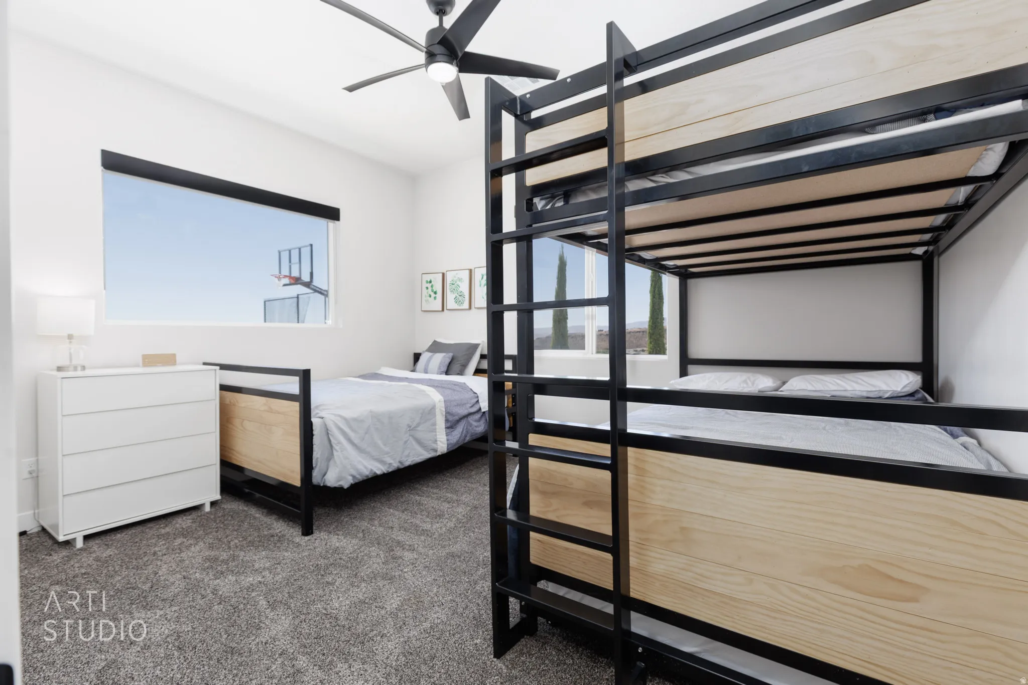 Spacious room featuring a large horizontal window and carpeted flooring