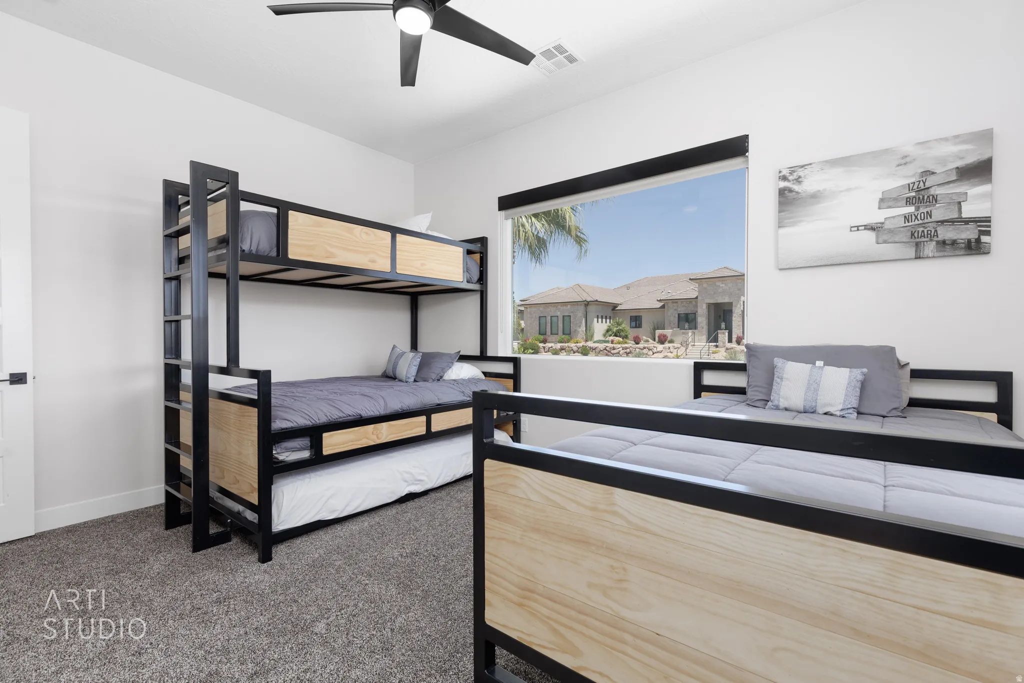 Room featuring a large window, a ceiling fan, and carpeted flooring