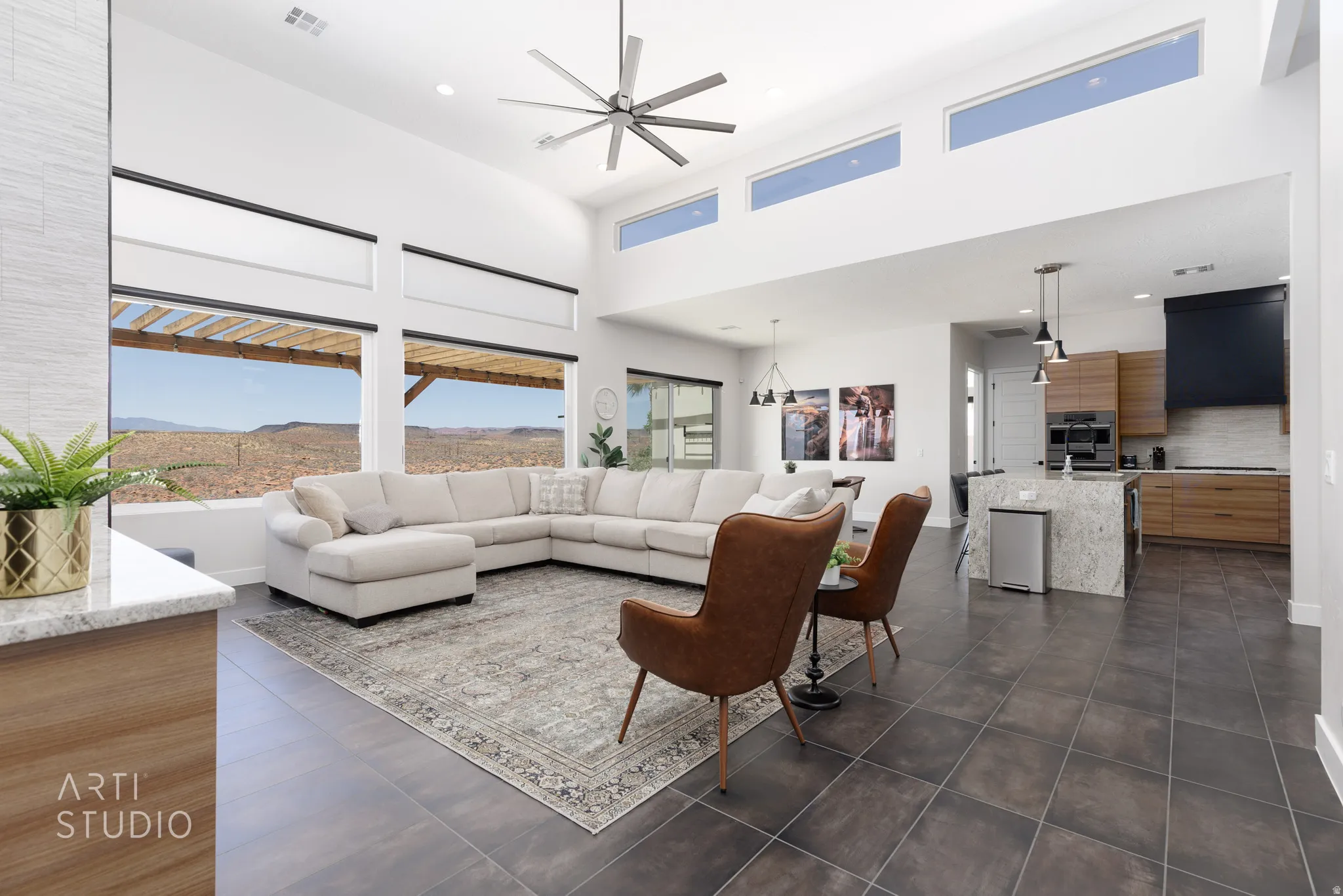 Spacious open-concept living area with high ceilings and transom windows