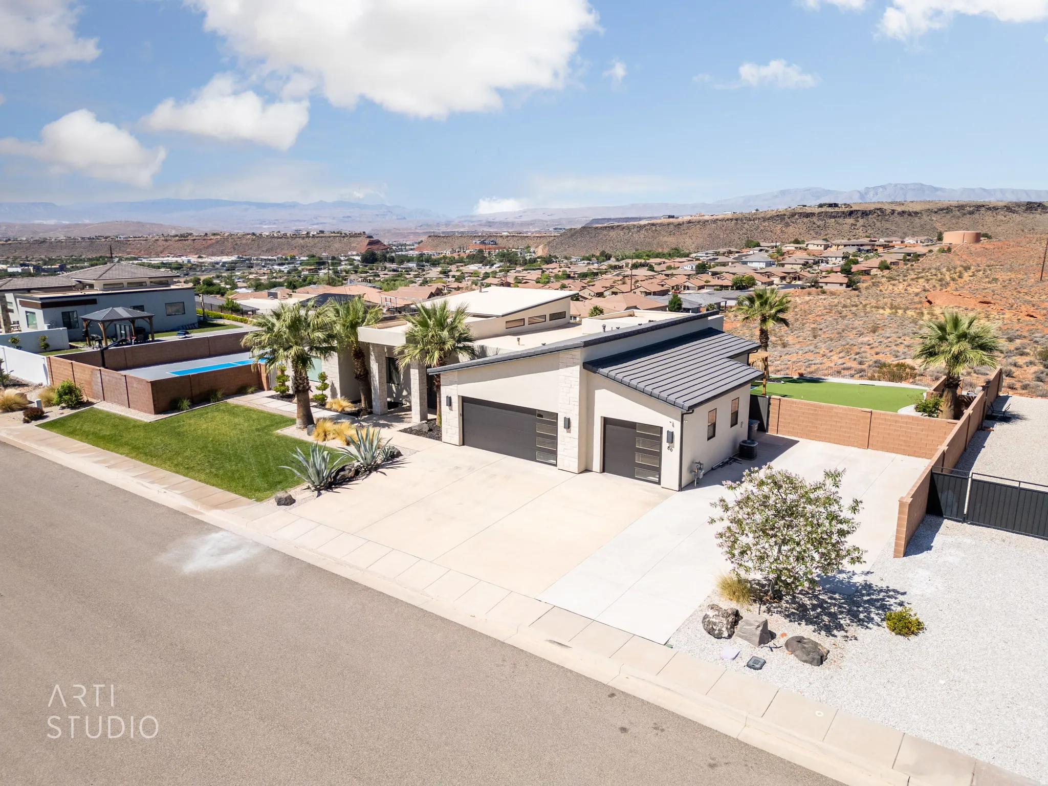 Contemporary exterior featuring a stucco finish and a multi-level roofline