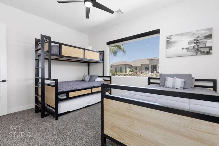 Room featuring a large window, a ceiling fan, and carpeted flooring