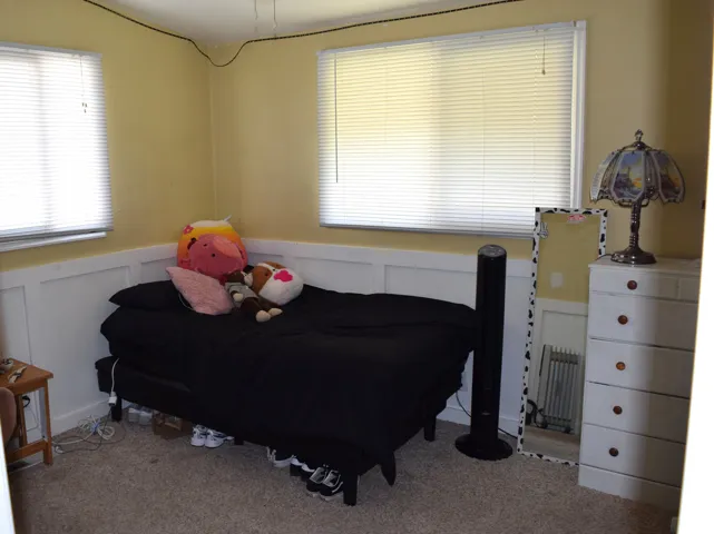 Room featuring light-colored walls and white wainscoting