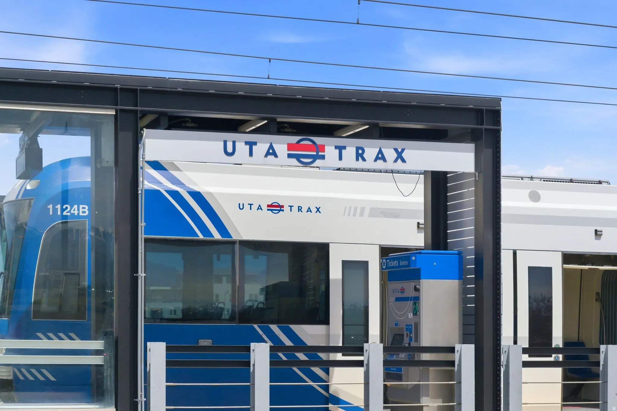 UTA TRAX light rail station featuring a blue and white train
