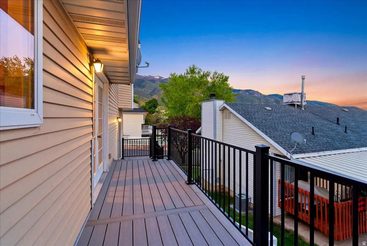 Composite deck with black metal railing, offering expansive mountain scenery