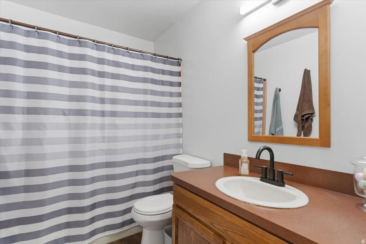 Bathroom vanity featuring a built-in sink and a rich-toned countertop