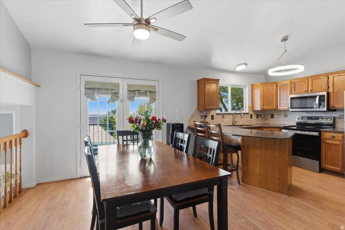 Kitchen and dining area featuring wood-finish flooring
