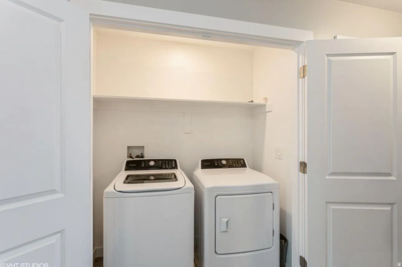 Dedicated laundry closet featuring a top-load washing machine, front-load dryer, and an upper storage shelf