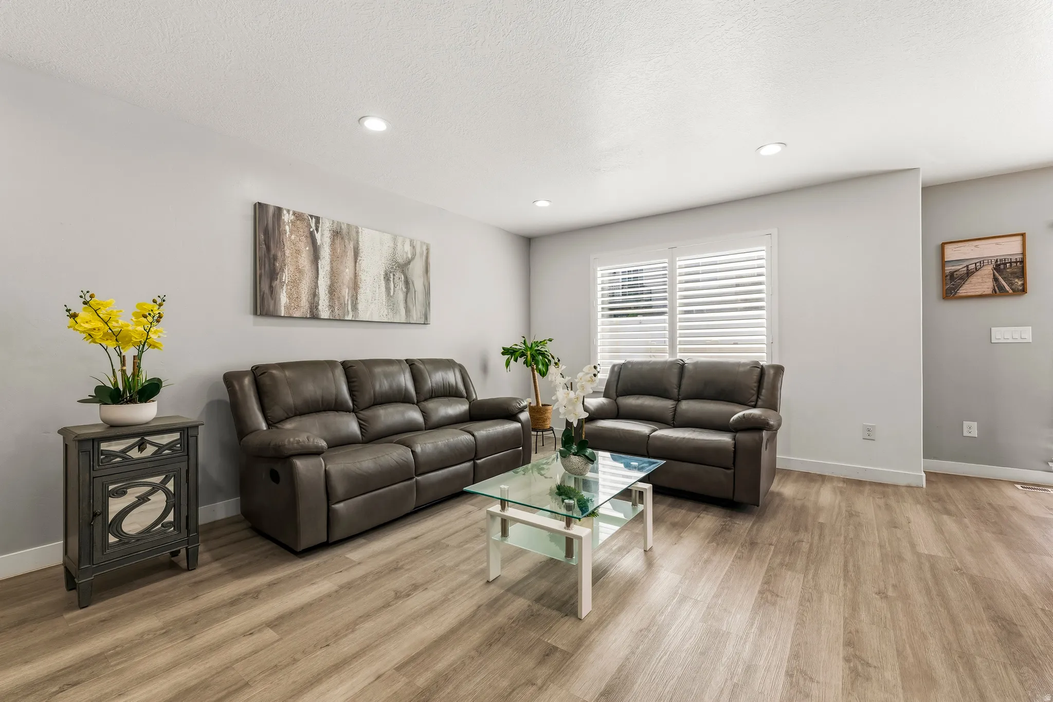 Living space featuring recessed lighting, light-colored walls, and wood-finish flooring