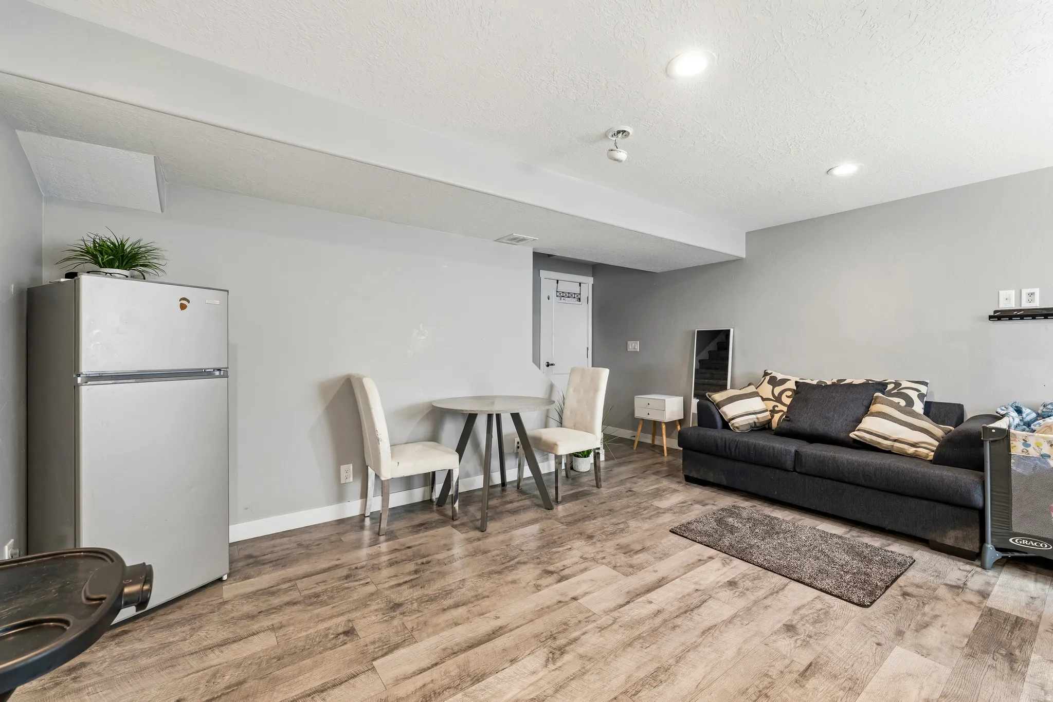 Versatile interior space featuring wood-finish flooring and recessed lighting