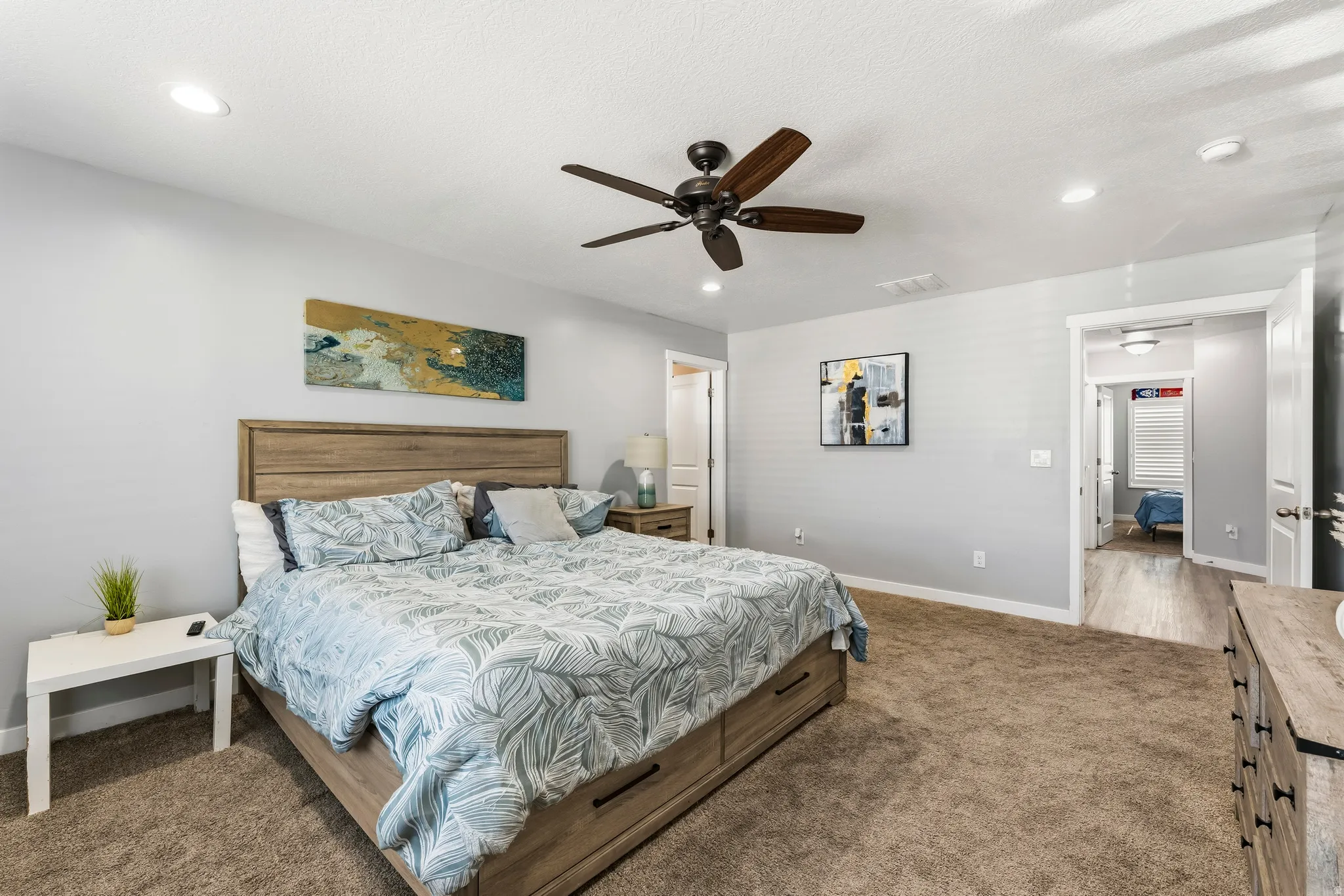 Bedroom featuring light gray walls, recessed lighting, a ceiling fan with dark wood-finish blades, and brown carpet flooring