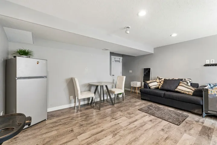 Versatile interior space featuring wood-finish flooring and recessed lighting