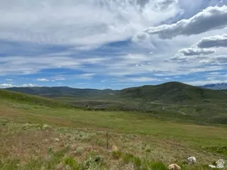 Expansive mountain land featuring a rolling topography and a verdant landscape