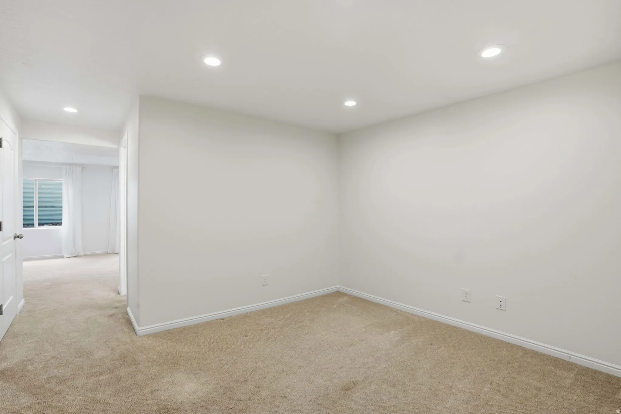 Carpeted room with recessed lighting and white walls